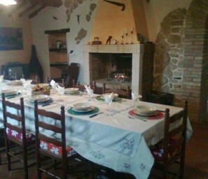 The venerable large dining room with open fireplace.