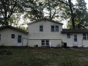 Backside of house with big almost half acre backyard with fence