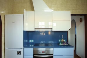 The kitchen is fully equipped with plenty of storage space