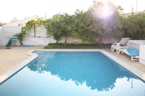 Pool with orange trees in the morning sun