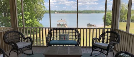 Screened in porch with lighting, ceiling fan,  and large TV 