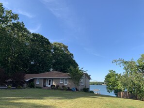 Front of house with large and flat front yard for recreation. 