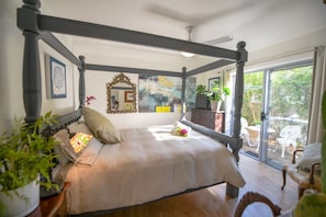 Main Bedroom with queen size 4 poster bed sliding door to a private courtyard