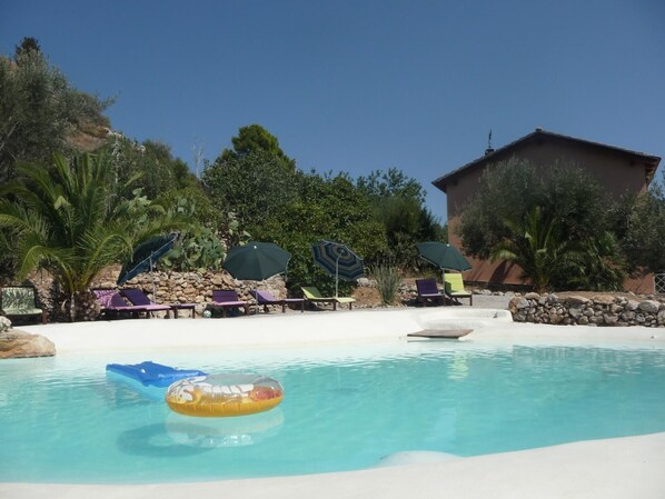 Pool. The natural lake-shaped pool amd the 2 bodies with the  tworoom suites and the threerooom suites in the background
