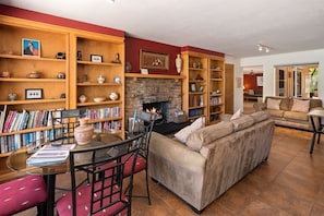 Warm open living spaces with stone fireplace feature