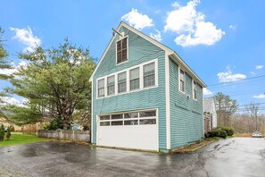 View of garage from parking area and driveway