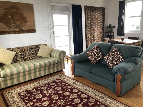 Really comfy and bright lounge furniture. Dining table & chairs in background.