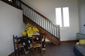 living room with stair going to loft bed