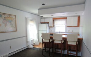 The Kitchen and the Breakfast Bar in the Long Open Concept Main Floor