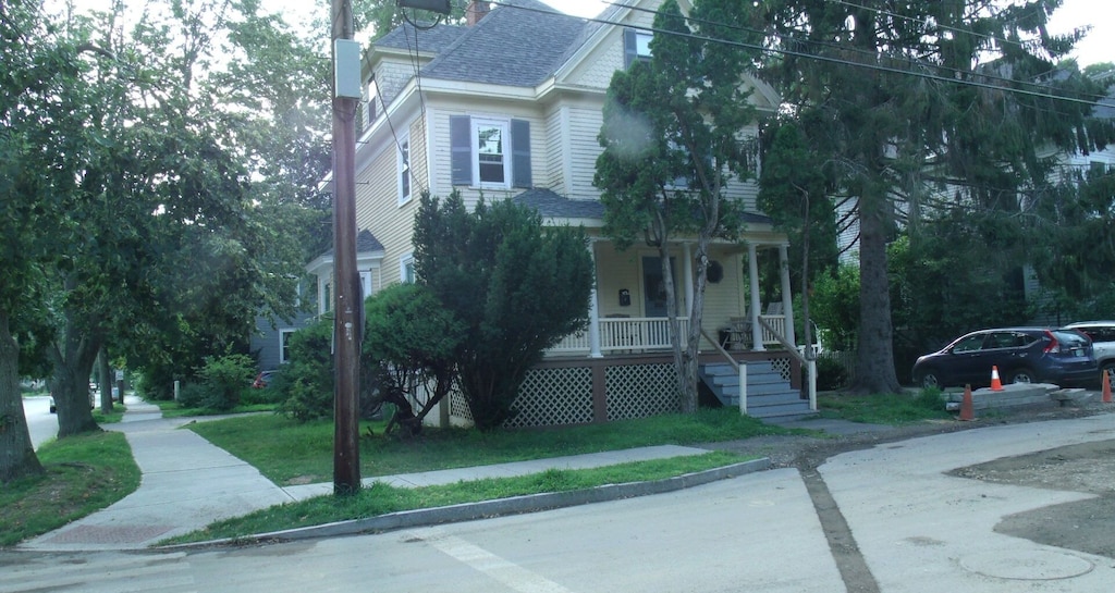 The exterior of a vacation rental in Portsmouth is partially hidden by trees