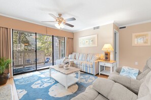 The living room has a beautiful view of outside wildlife and Arrowhead Lake.
