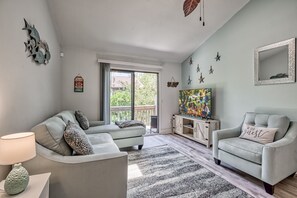 Living room with queen size pullout sleeper sofa and access to balcony