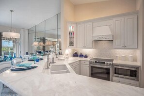Gorgeous marble counter tops adorn the eat-in kitchen bar