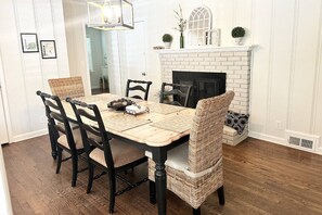 Breakfast table sits between the family room and the kitchen.