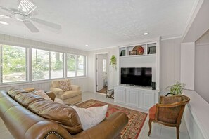 Enjoy this cozy family/tv room at the back of the house with tile flooring and the breakfast area to your right
