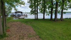 View of the permanent dock at the waters edge.  Shady wooded area - very private