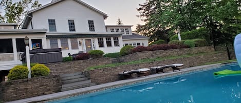 Another look from the pool to the house, fire pit, hot tub and screen porch