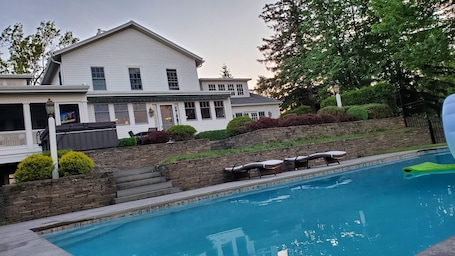 Another look from the pool to the house, fire pit, hot tub and screen porch