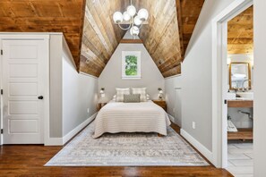 Primary Bedroom with high vaulted ceiling.