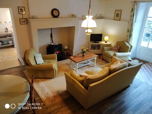 
the sitting room with french windows ontp the sunny terrace