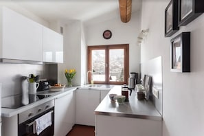 This well-equipped kitchen has a dishwasher and full-sized oven and hob 