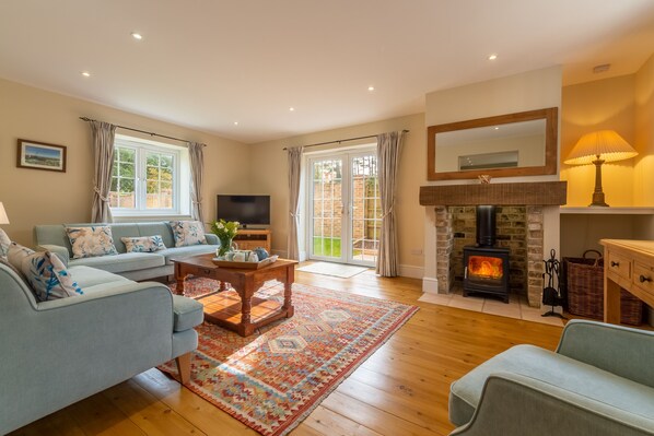 1 Hall Lane Cottages, Thornham: Sitting room with wood burning stove