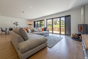 The Chapter House, Little Walsingham:  Open plan living area with wood burning stove