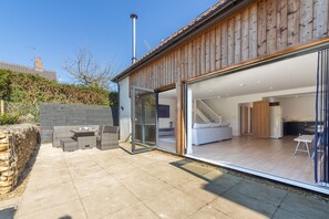 The Chapter House, Little Walsingham: Bi-fold doors open to the patio and enclosed garden