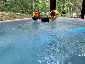 Relax in the hot tub overlooking the fire pit and woods!