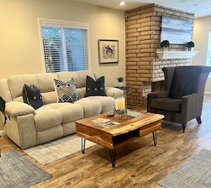The living room features comfortable furnishings.