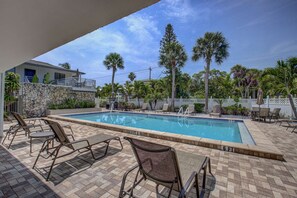 Smaller of the two heated pools with loungers and shade when needed.