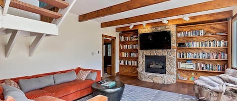 Family room with gas fireplace and mounted TV