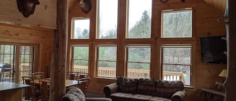 The great room exudes character with  gorgeous cathedral ceiling and cedar posts