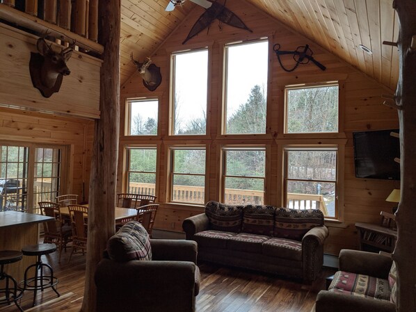 The great room exudes character with  gorgeous cathedral ceiling and cedar posts