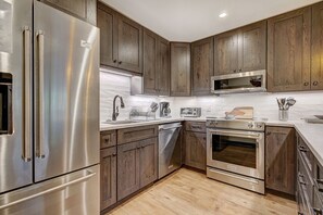 Fully equipped gourmet kitchen with modern stainless steel appliances