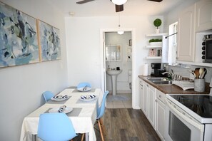 Prepare your favorite meals in our well-equipped kitchen, complete with a stove, microwave, and all the essentials. The adjacent dining area offers a lovely spot to gather and enjoy your culinary creations, making it perfect for both quick bites and leisurely meals.