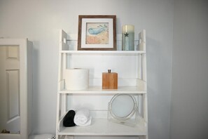 We've thoughtfully stocked the bathroom shelves with essentials and a few extra comforts to make your stay even more enjoyable. You'll find fresh towels, extra toilet paper, and a magnifying mirror for your convenience.