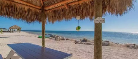 Relax by the beach under the cool shade of our tiki hut