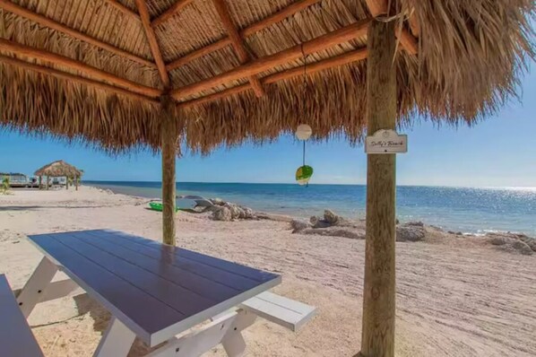 Relax by the beach under the cool shade of our tiki hut