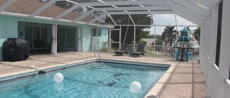 Large Lanai with a view down the canal and heated pool