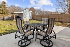 Back patio with seating for 4 and fire pit. Fenced in backyard