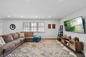 Sectional couch with tv, games, and a desk for working space. Beware of step down