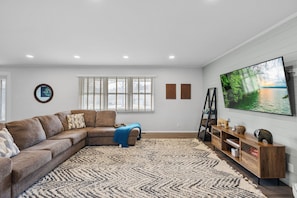 Sectional couch with tv, games, and a desk for working space. Beware of step down