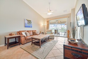BT1426 - Living with comfortable seating and flat screen TV. Sliding doors open up to the screened in lanai with lake view!