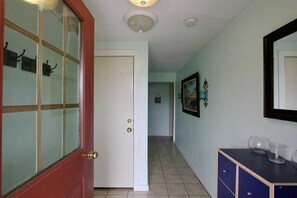 Main entrance. Door to unit and hallway to basement for access to laundry. 
