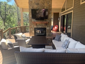 outside lounge area with TV and fireplace viewing