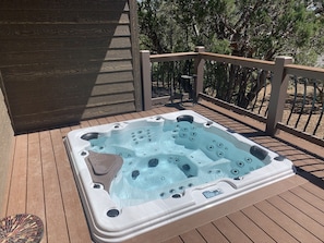 Hot tub in deck, has a lockable cover. 