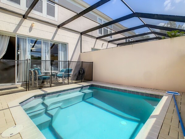Relax by the sparkling private pool with a screened enclosure for ultimate comfort.