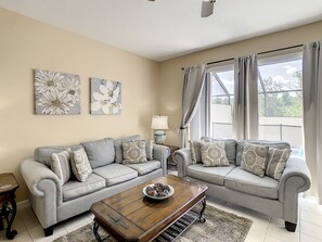 Bright and inviting living room with plush seating and natural light for relaxing evenings.