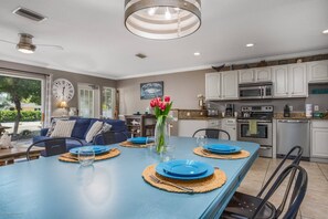 Large dining table for 6 people next to the kitchen.  Whip up your favorite meals at home!